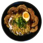 Chashu ramen bowl with pork belly slices, green onions, marinated egg, and rich broth