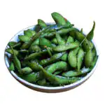 A bowl of steamed edamame soybeans lightly salted, served in pods