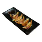 Six pan-fried Japanese gyoza dumplings served with dipping sauce