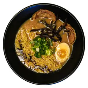 Bowl of miso ramen with medium noodles, marinated egg, vegetables, and savory miso broth