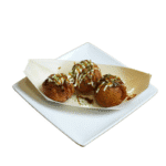 Three takoyaki balls topped with mayo, takoyaki sauce, and bonito flakes
