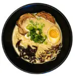 Bowl of Tonkotsu ramen with creamy pork broth, noodles, and traditional toppings