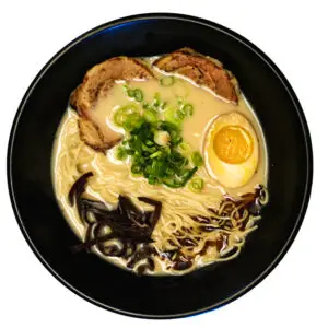 Bowl of Tonkotsu ramen with creamy pork broth, noodles, and traditional toppings